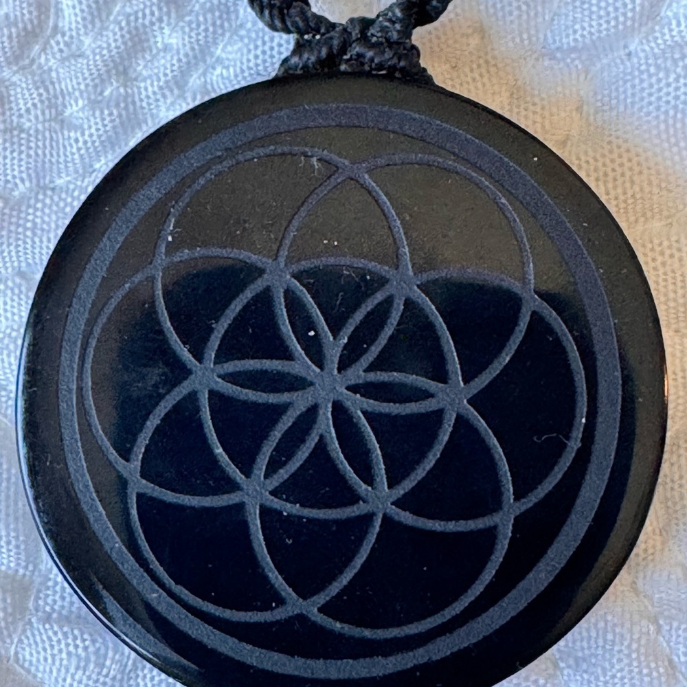 Black Circular Pendant with Geometric Design
